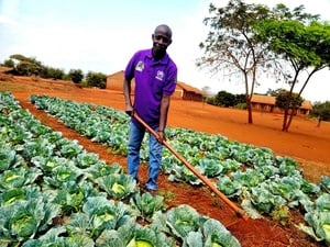 Tanzania. Ephrahim Nyandwi, a teacher and environmental advocate, works in the school garden at Mapendo Secondary School in Nyarugusu Refugee Camp