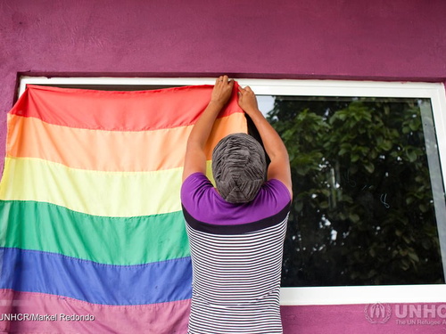 Electra and LGBT refugee from Honduras hanging up the rainbow flag at the LGBT module at La 72 migrant shelter in Tenosique, Tabasco, Mexico.