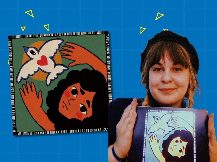 Virag holds up her design, a painting of a young girl releasing a dove with a heart on its back