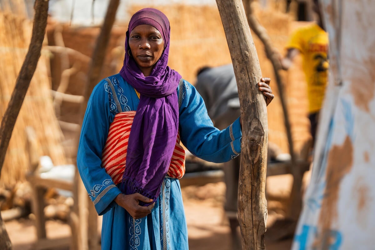 Portrait of a woman wearing a purple headscarf.