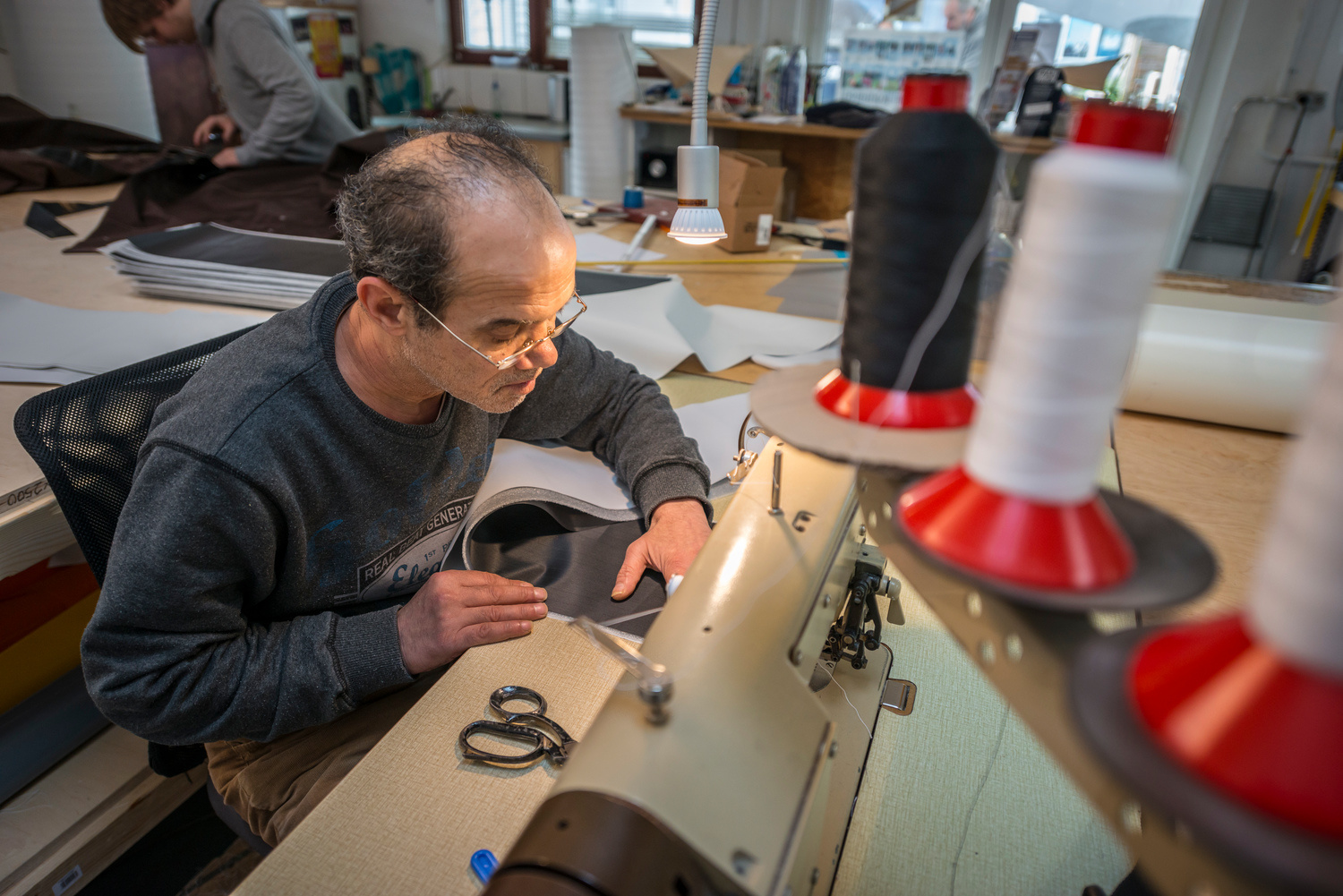 Germany. Syrian father and son use sewing skills to start new lives