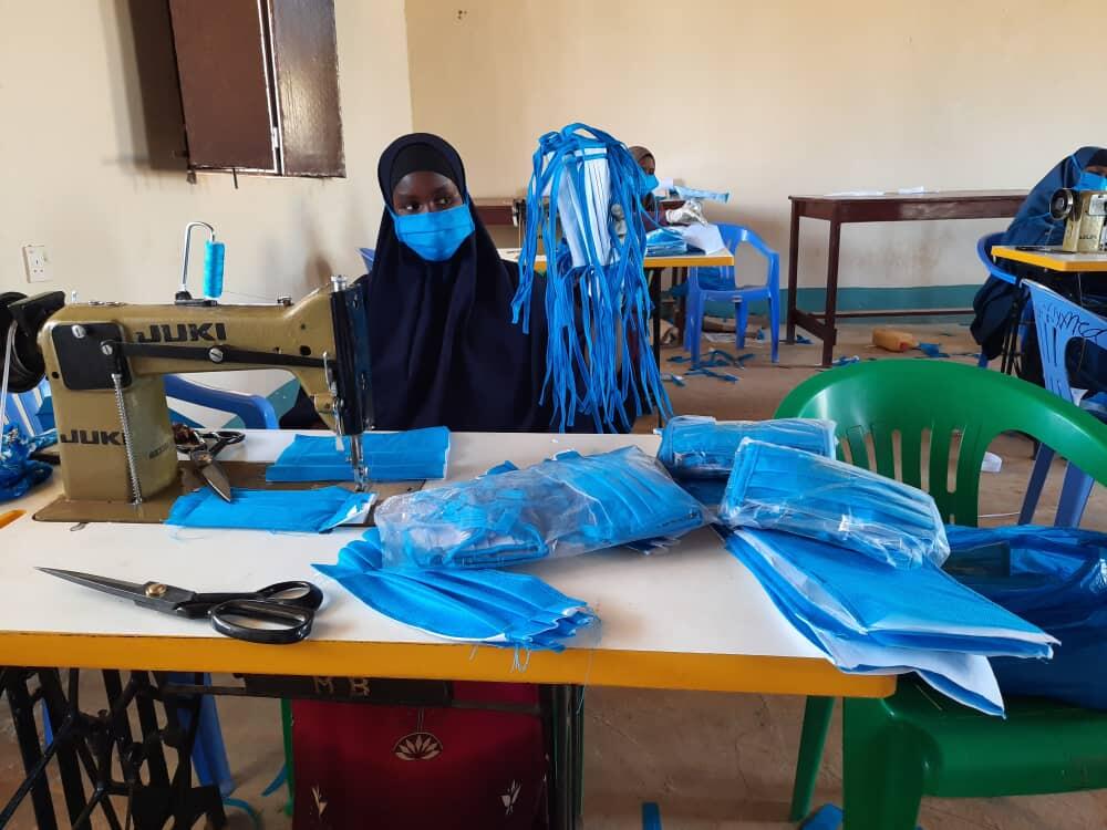 Somalia. Refugees make masks 