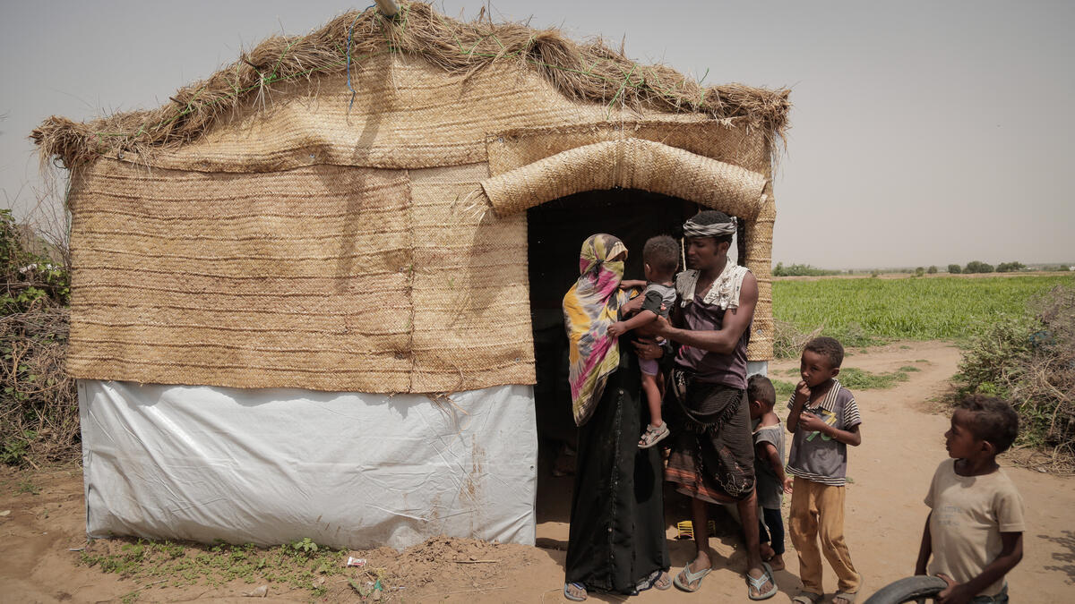 Yemen. An internally displaced family outside their shelter in Al-Hudaydah
