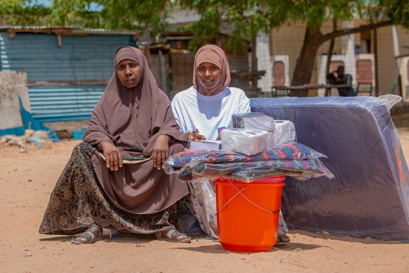 With school necessities at her side, Bisharo shares a moment with her mother before leaving her home in the Dadaab refugee complex in Kenya, to join a secondary school in the capital, Nairobi.