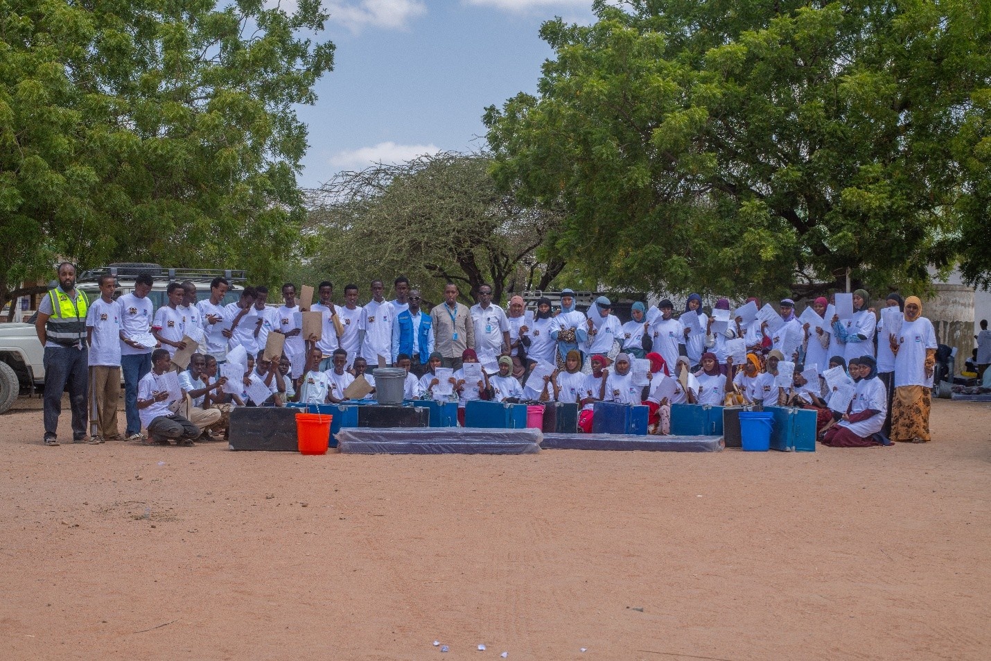 Some of the refugee students departing Kenya's Dadaab refugee complex for secondary schools across the country with UNHCR staff and Elimu Scholarship representative ahead of their journey.