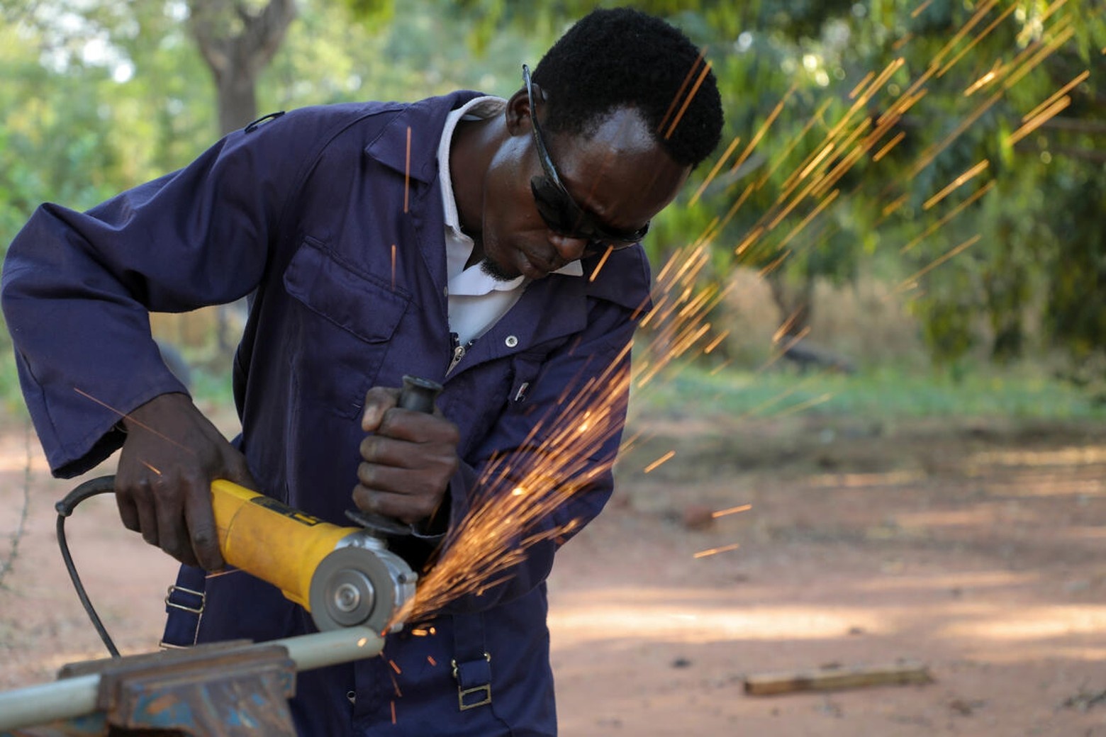 Mangisto Abdurahman, a Sudanese refugee, works his metallic grinder at the Ajoung Thok Vocational Training Centre in South Sudan.