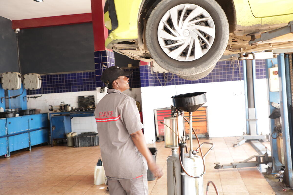 Senegal. Cameroonian refugee Marie Etah at her place of work Eminence Motors Garage (EMG) in Dakar.