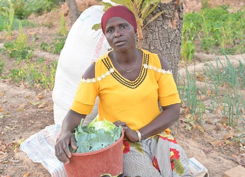 Burkina Faso. IDP Marie Dabini after cabbage harvest at INERA Fada