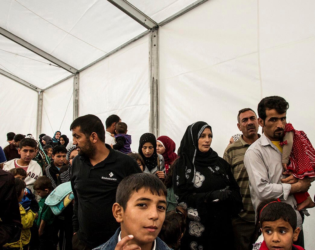 Syrian refugees queue up to be registered at the UNHCR registration offices in Amman, Jordan