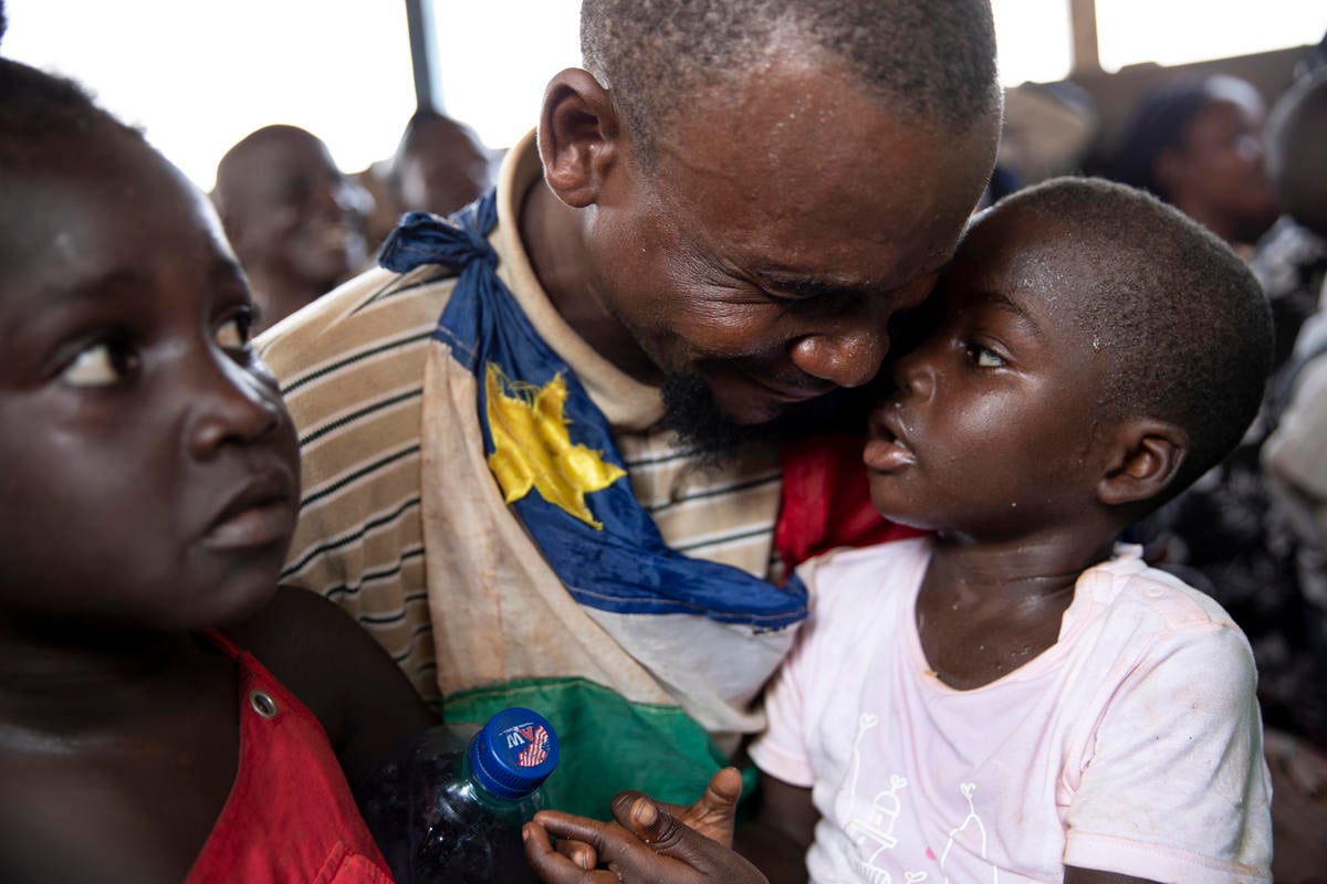 Central African Republic. A returnee cries on his way back home