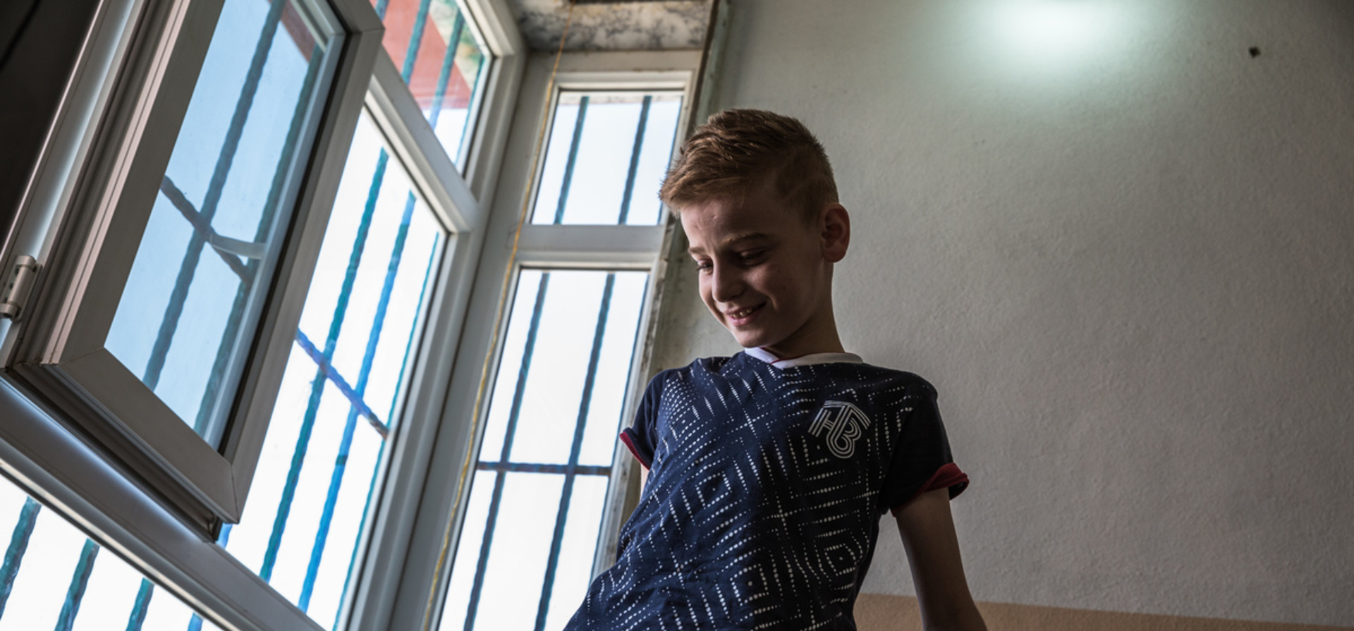 Iraq. Yazidi child gets ready to reunite with his mother in Canada