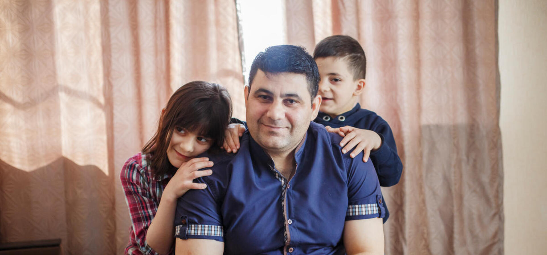 Belarus. A Syrian refugee and his children spend Sunday together in their new home in Gomel