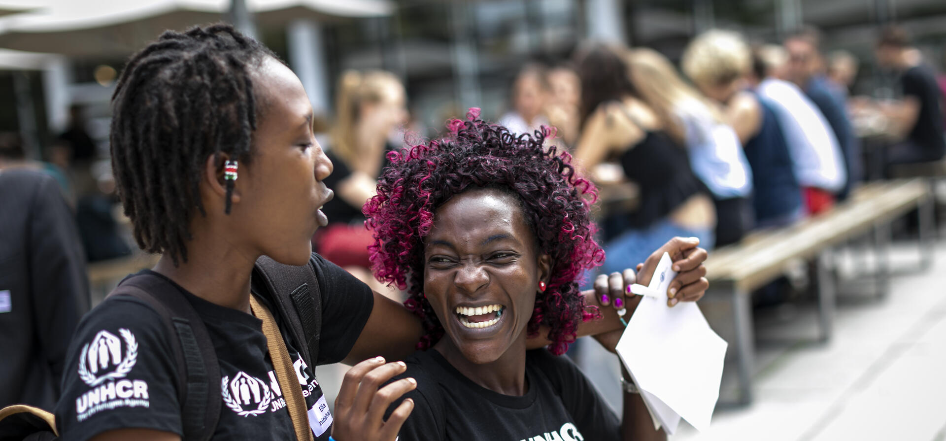 UNHCR, the UN Refugee Agency - Two participants from the Step with Refugees challenge are laughing and enjoying each others company on the Free University of Berlin Campus. 