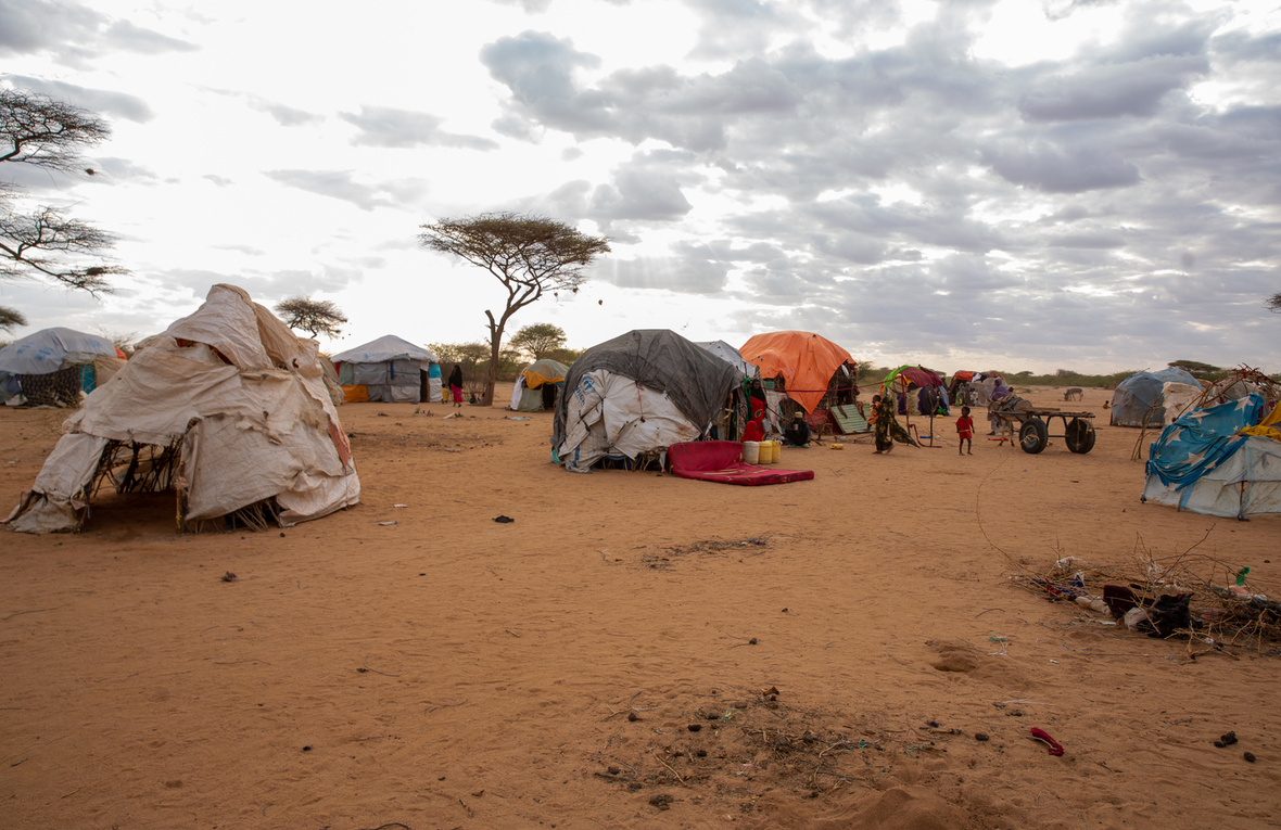 Makeshift shelters in an arid landscape.
