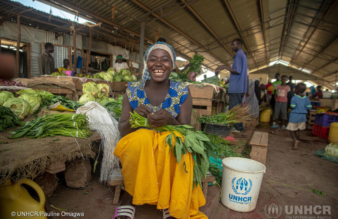 Komaliza Consolata at her vegetable stand at the Kalobeyei market in Kenya.