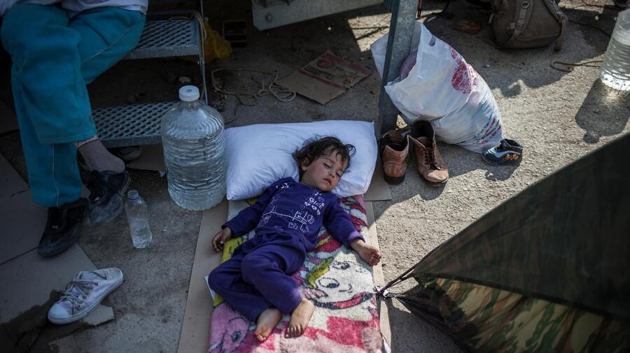 A child sleeps outside the screening centre at Moria on Lesvos.