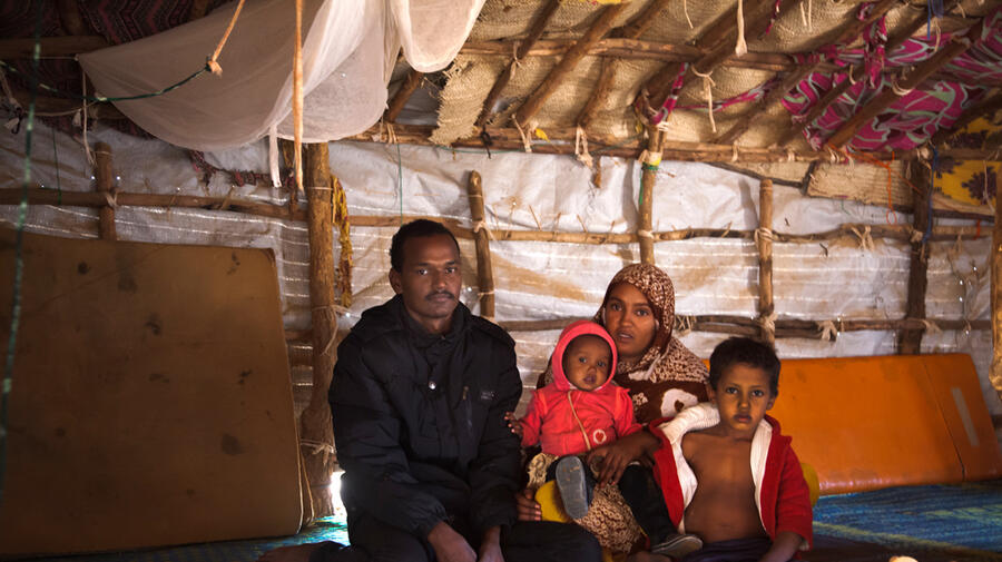 Jafar poses with his wife Zeinabou, their baby daughter Fadimata and they nephew Sidi in their shelter in Mentao refugee camp, Burkina Faso