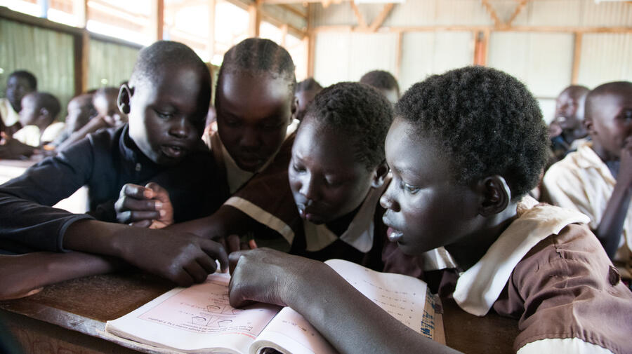 Kenya. Students share a textbook in Kakuma