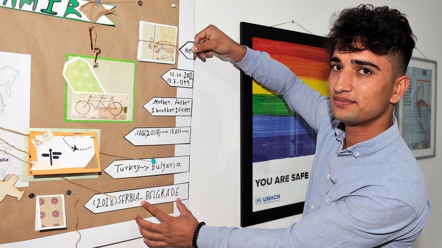 Arsalan points to a poster at a workshop on the risks of exploitation and trafficking in Belgrade, Serbia. The workshop is for unaccompanied children. 
