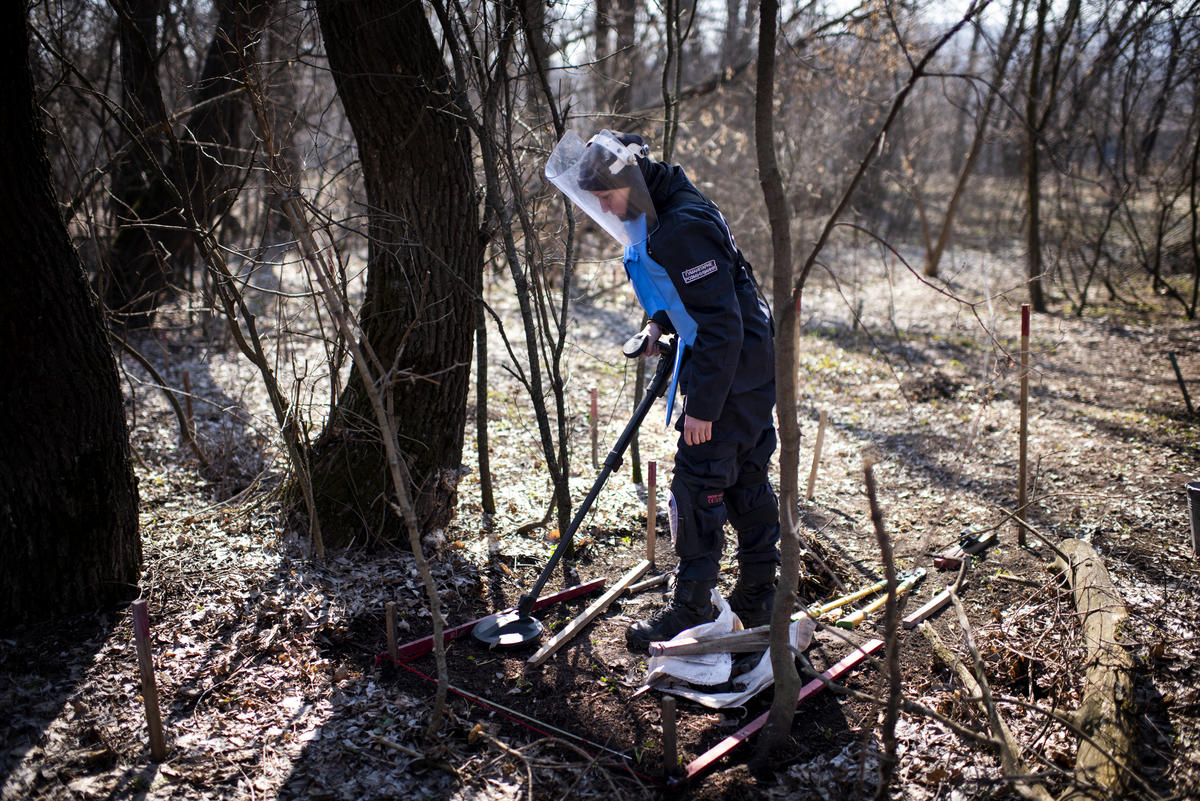 Ukraine. A female deminer uses a metal detector to look for landmines in the Donbas area