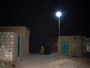 Hukumrana and her friends chat under a solar streetlight in front of their houses.