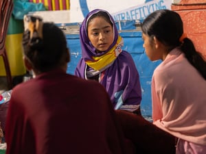 Aysha sits and talks with her peers in the Rohingya refugee camps in Cox's Bazar, Bangladesh.
