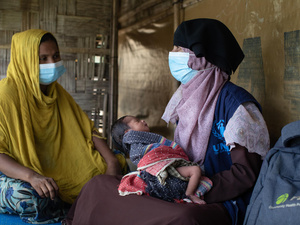 Bangladesh. Community health volunteer helps Rohingya mothers with post-natal care