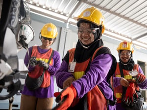 Thailand. Refugee workers from Myanmar prepare for work by putting on safety equipment