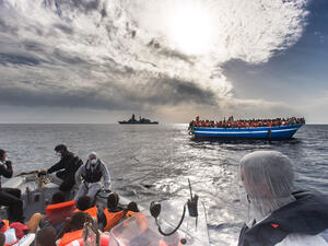 SOS: the Italian navy helps a boatload of people trying to reach Europe from North Africa.
