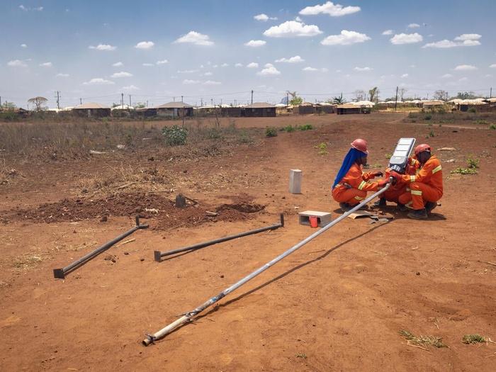 Displaced people install a new street light at Corrane IDP site in Nampula Province, Mozambique.