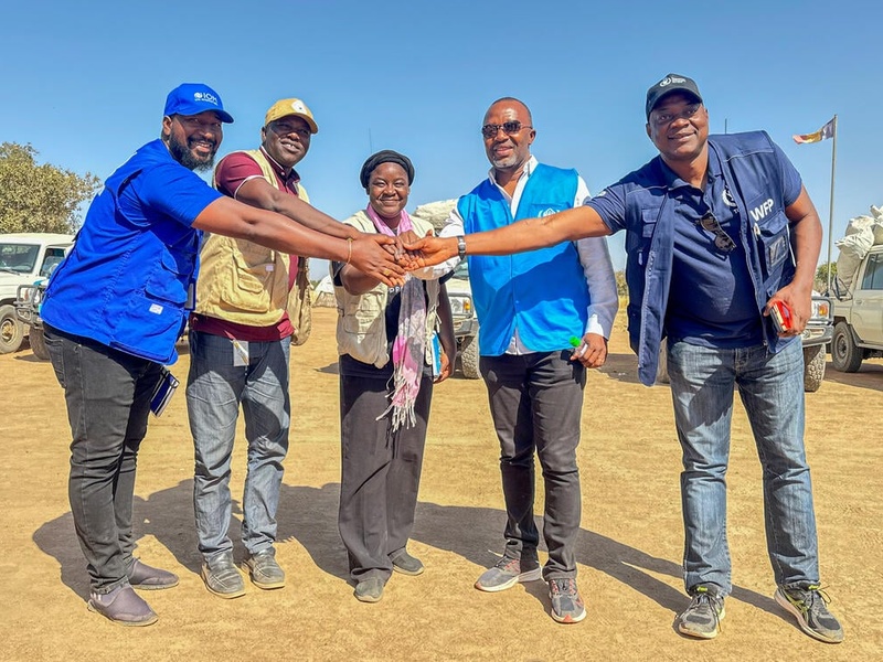 At a refugee settlement in Chad, five UN staff members from different agencies put their hands together in a show of unity.