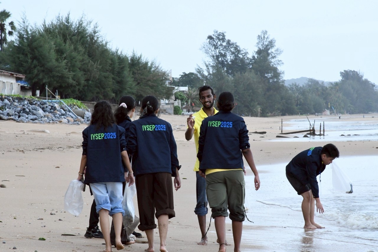A group of students at the beach participating in coastal activities.