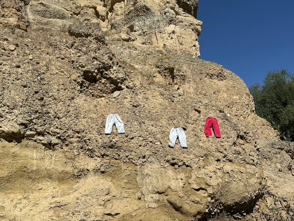 Family laundry dries outdoors on top of the cave, where displaced Afghan families live.
