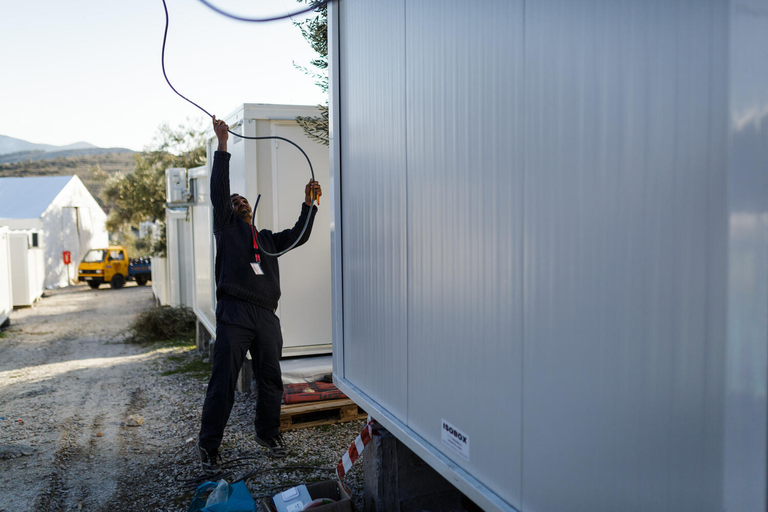 Greece. The Syrian electrician installing power at Lesbos refugee camp
