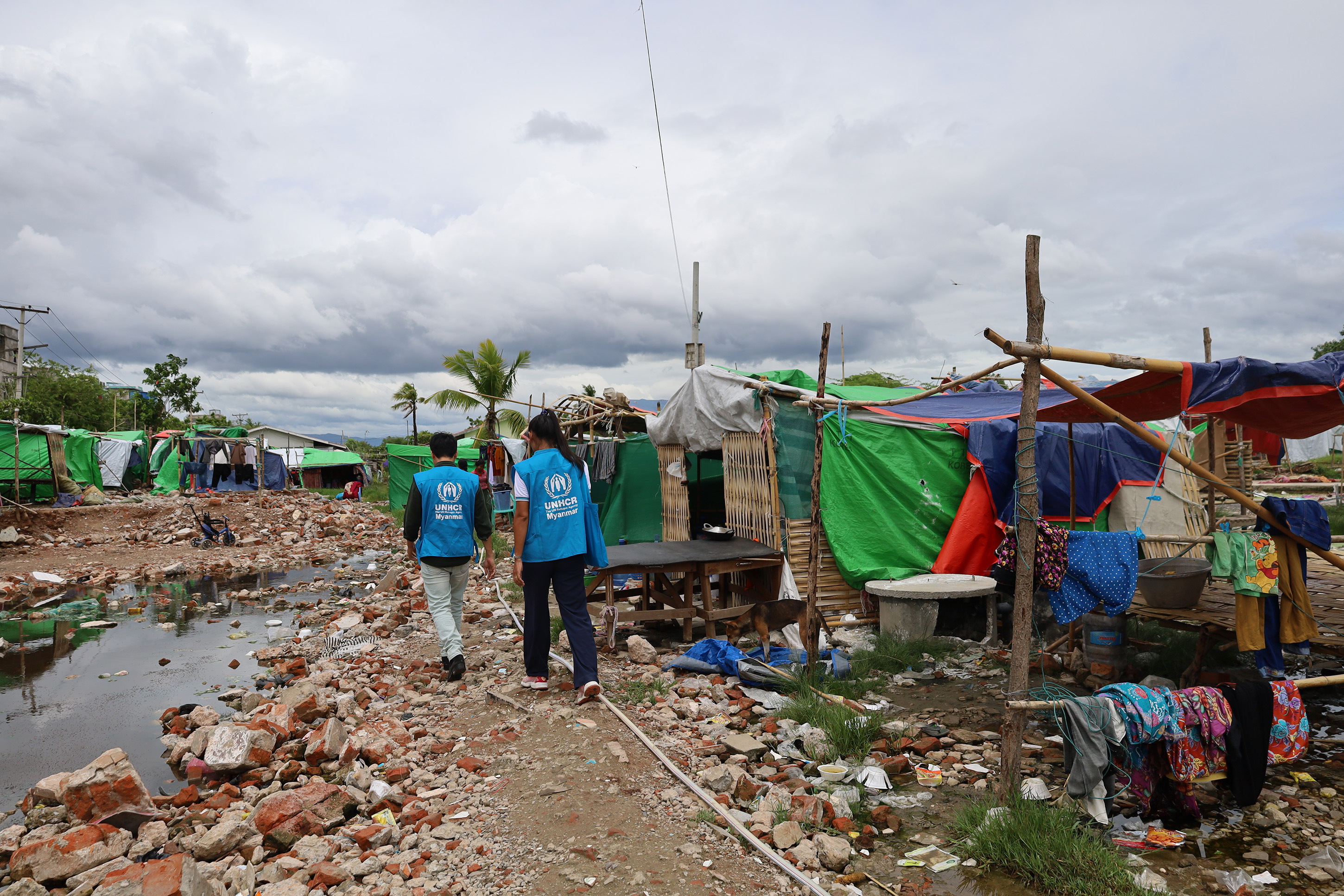 UNHCR staff walking through the earthquake damage in Manalay. 