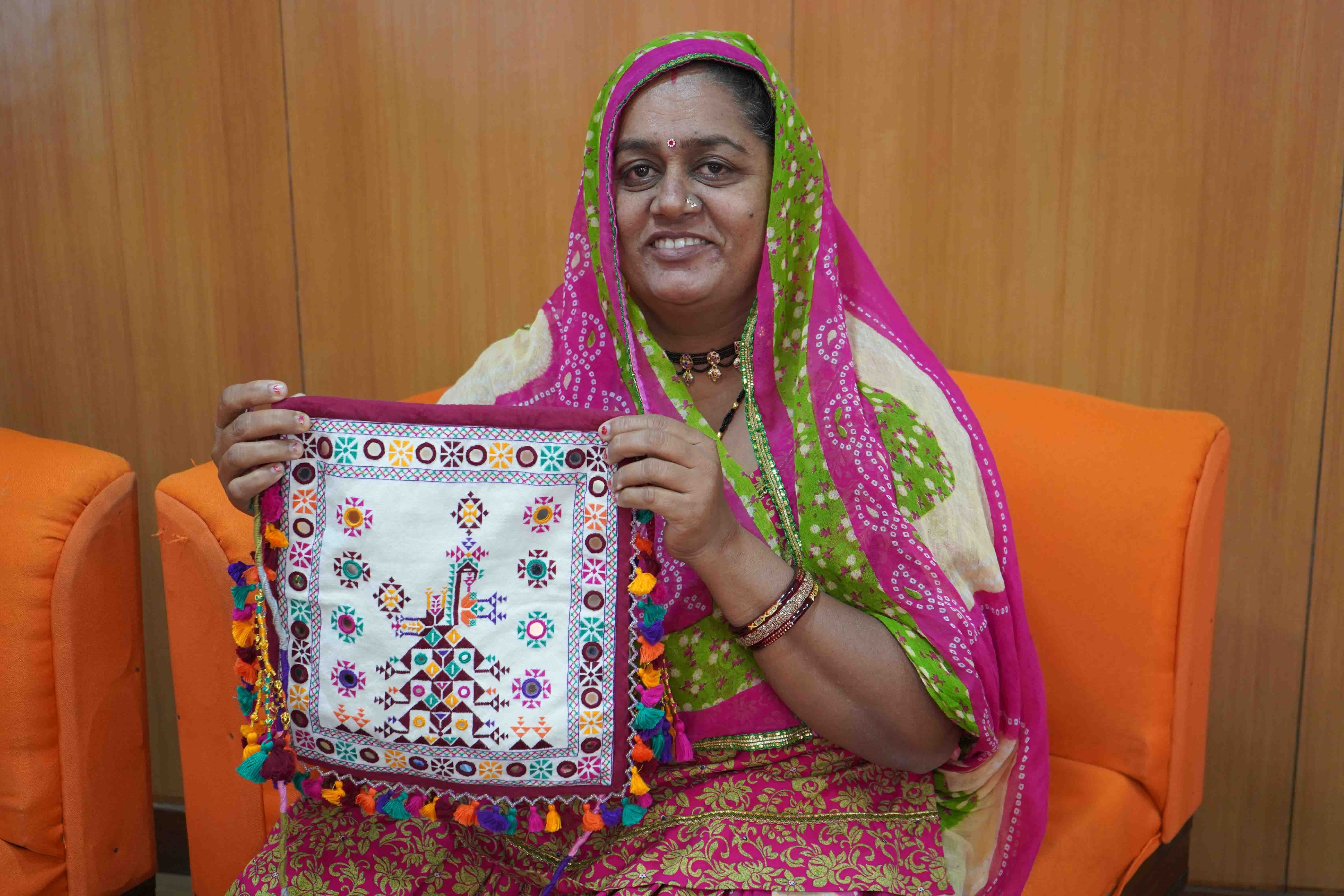 Parvatiben from Kutch proudly displays a handcrafted bag she created &mdash; embroidery that now contributes significantly to her family&rsquo;s income.