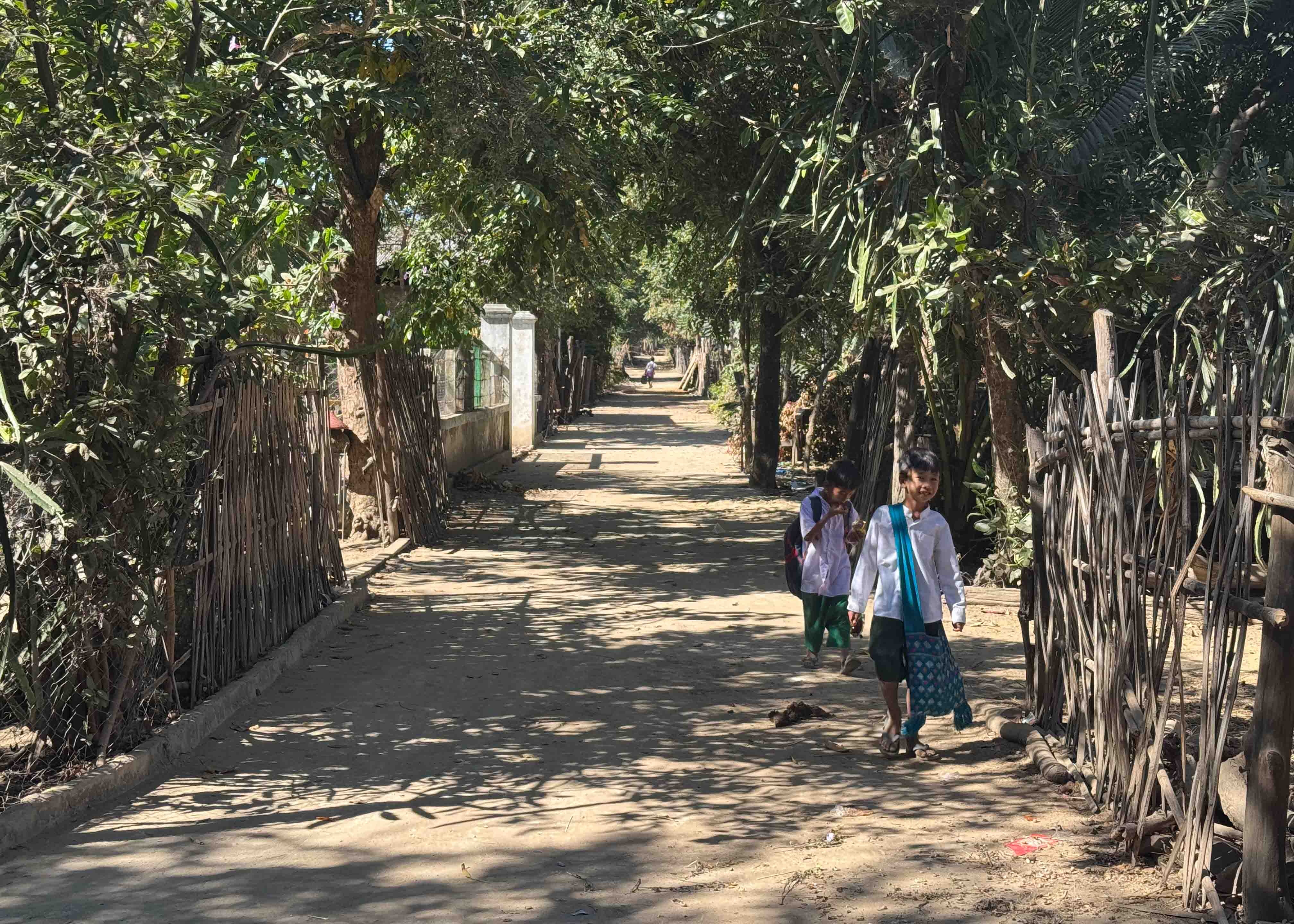 Two children walking on a newly constructed road.