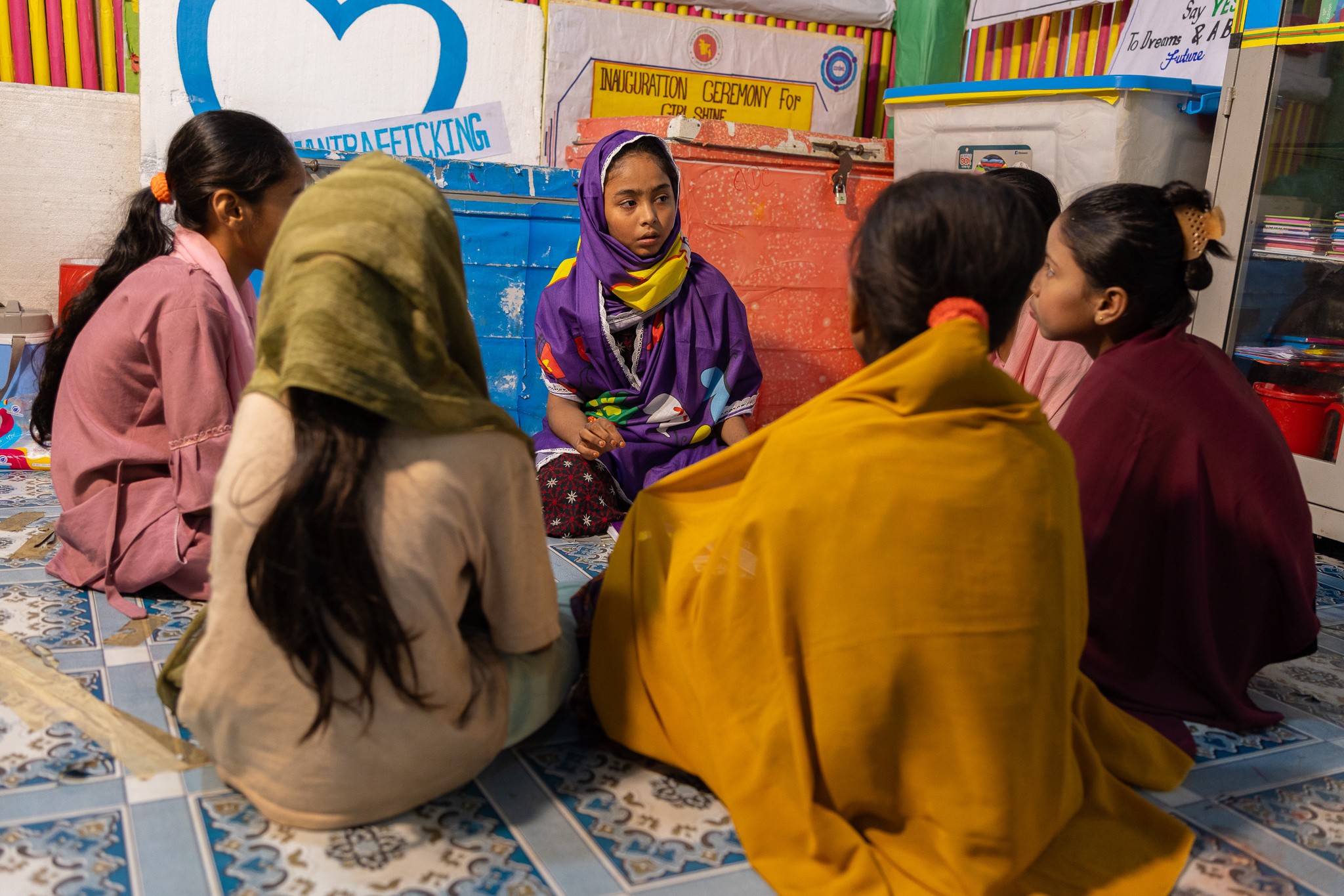 Aysha sits and talks with her peers in the Rohingya refugee camps in Cox's Bazar, Bangladesh.