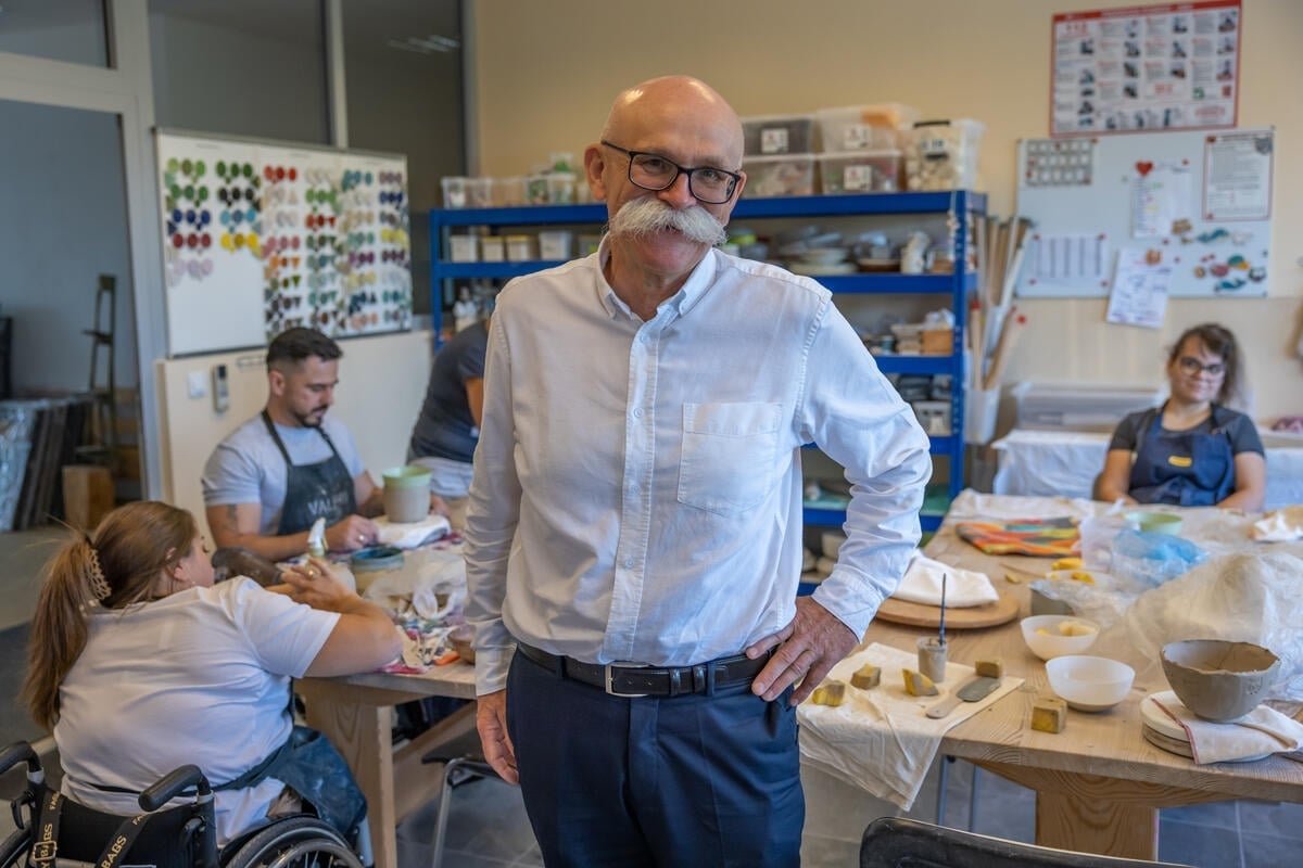 A man stands in a ceramics workshop.