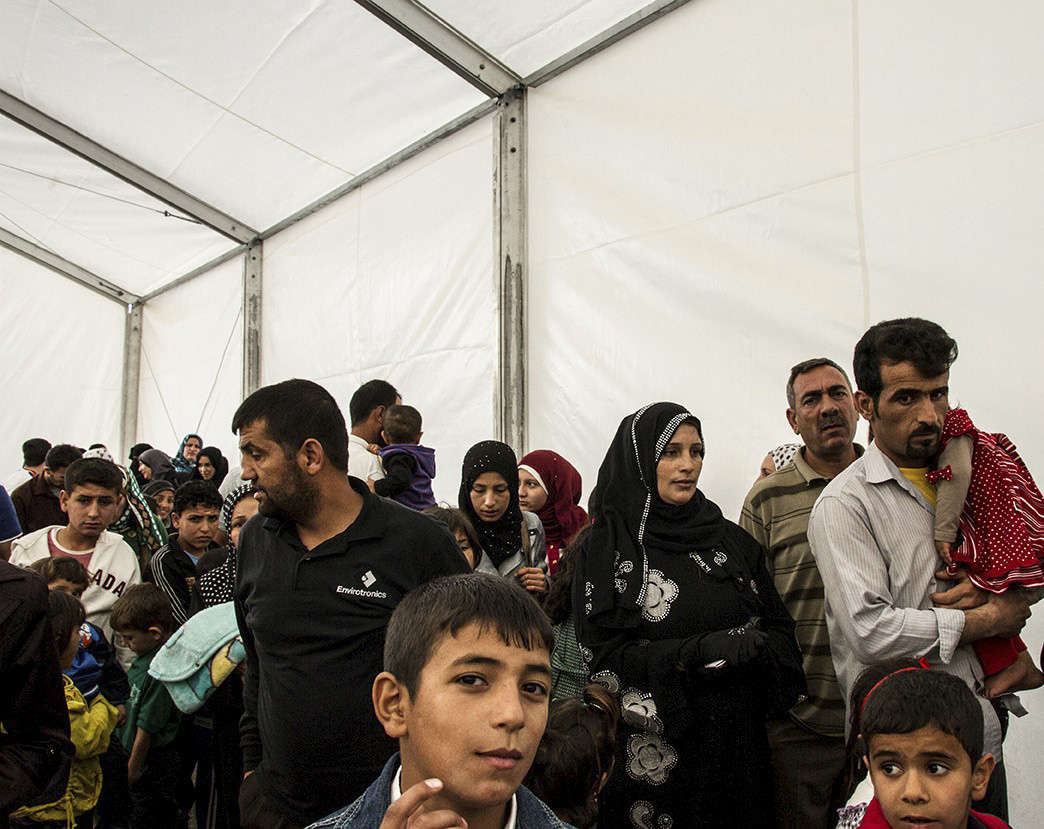 Syrian refugees queue up to be registered at the UNHCR registration offices in Amman, Jordan