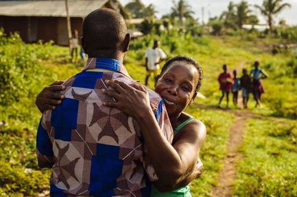 A former refugee from Côte d'Ivoire hugs his aunt.