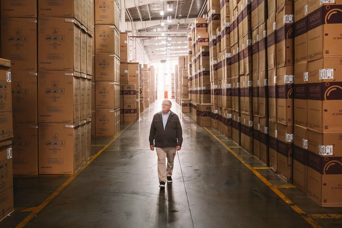 A man walks in the middle of a warehouse