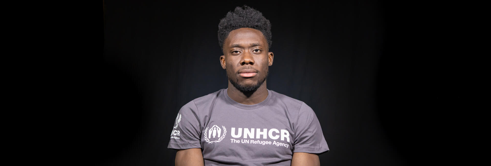 Alphonso Davies, Left Back for FC Bayern Munich and Canada Men's National Team wearing UNHCR t-shirt.