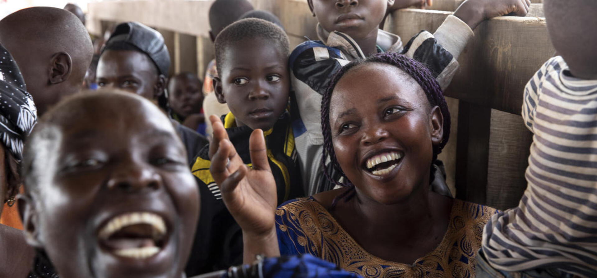 Central African Republic. Returnees sing and laugh on the boat back home