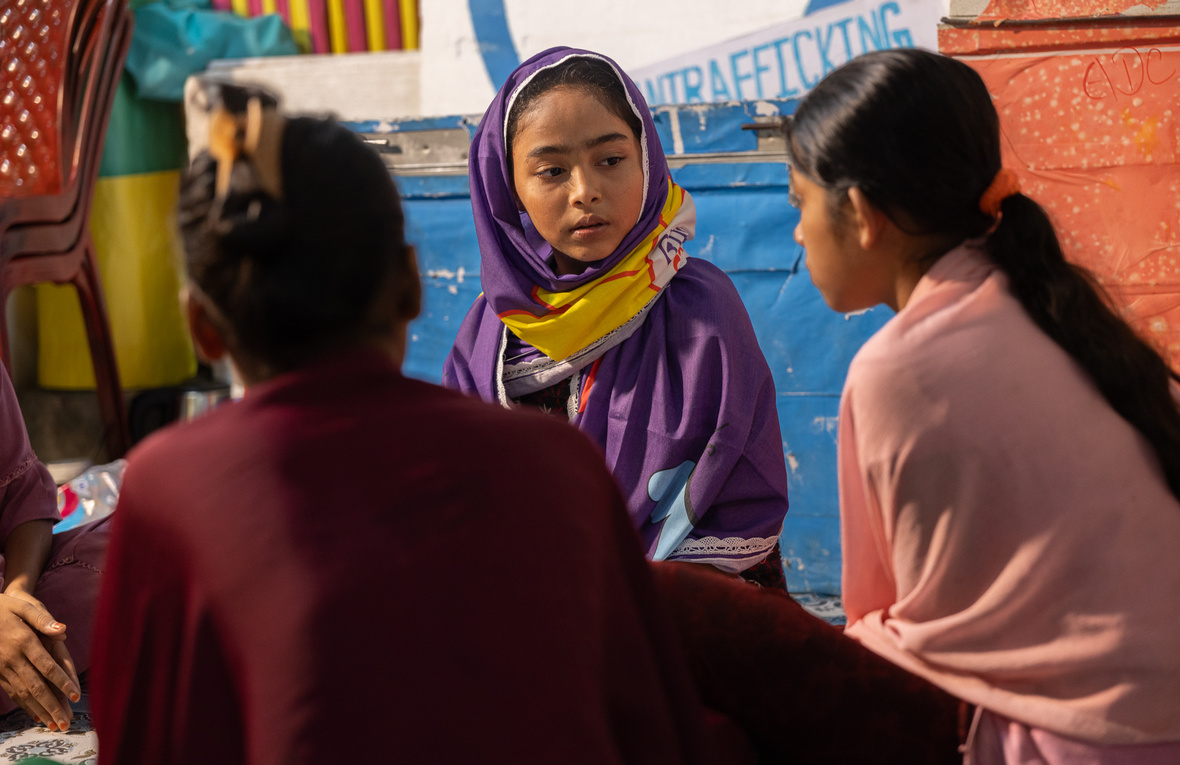 Aysha sits and talks with her peers in the Rohingya refugee camps in Cox's Bazar, Bangladesh.