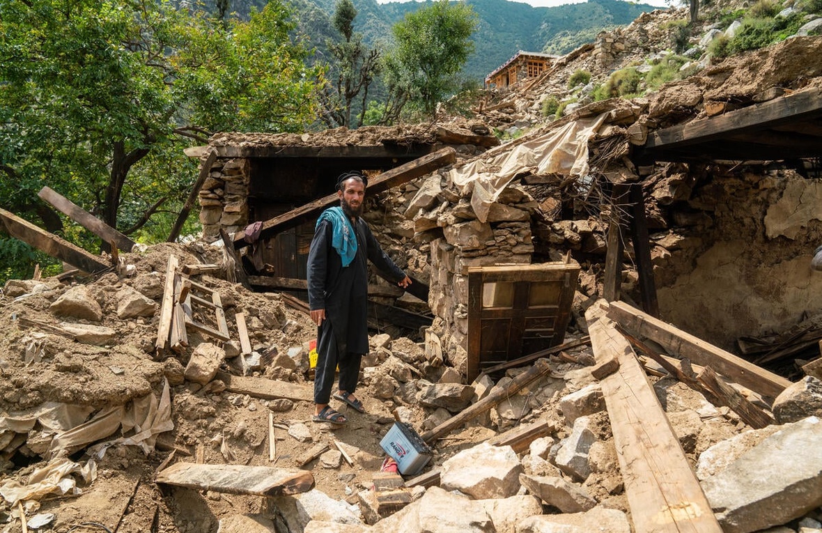 A man points at the rubble of his home following an earthquake in Kunar province, eastern Afghanistan.