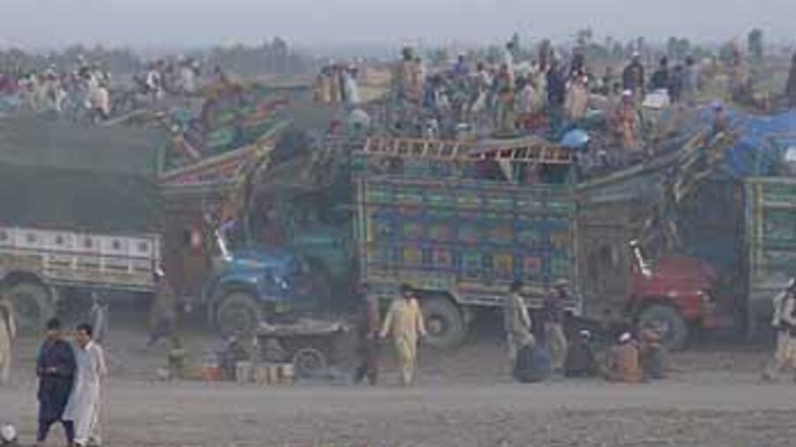 Afghan refugees returning home wait at the Takhtabaig Voluntary Repatriation Centre.