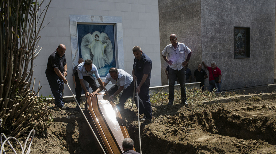 Italy. Burial of refugees.