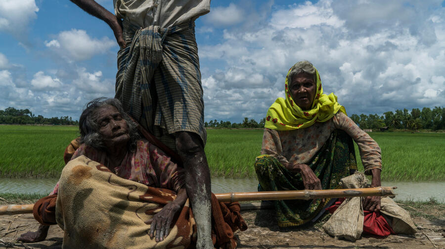 Bangladesh. An elderly Rohingya refugee is carried across the border