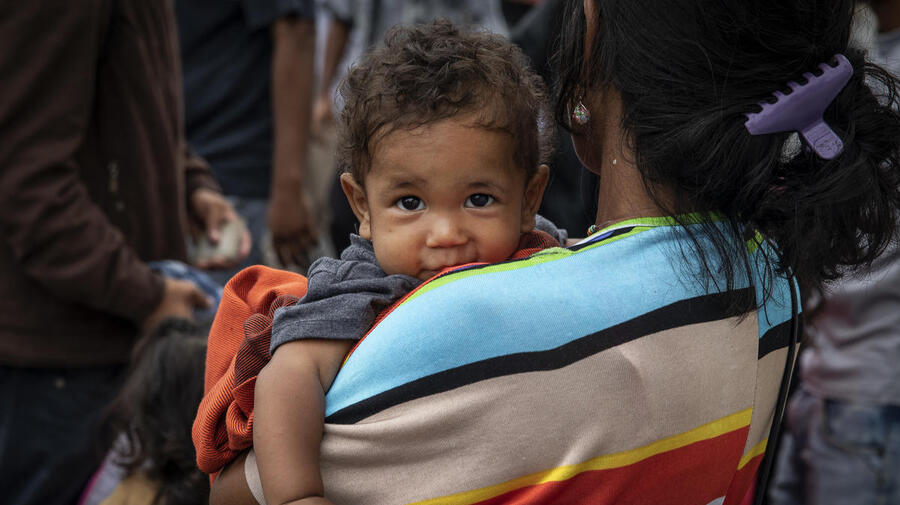 Colombia. A mother with her child crosses the Simon Bolivar Bridge, one of 7 legal entry points on the Colombia-Venezuela border